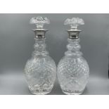 Pair of cut crystal decanters with silver collared necks. (Not apart of the estate)