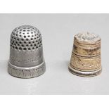 An antique pewter thimble dated 1840 for the marriage of Victoria and Albert, and a silver gilt
