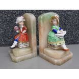 Pair of soapstone bookends with porcelain figures of children (damaged).