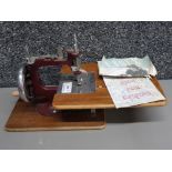 An Essex miniature sewing machine with instructions.