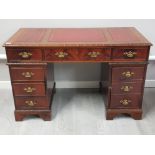 Flame mahogany twin pedestal desk with red leather top & brass handles