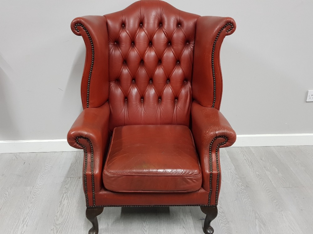 Metal studded red leather chesterfield wing back armchair
