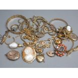 A bag of gold plated jewellery, including bangles, chains, lockets, brooches & rings