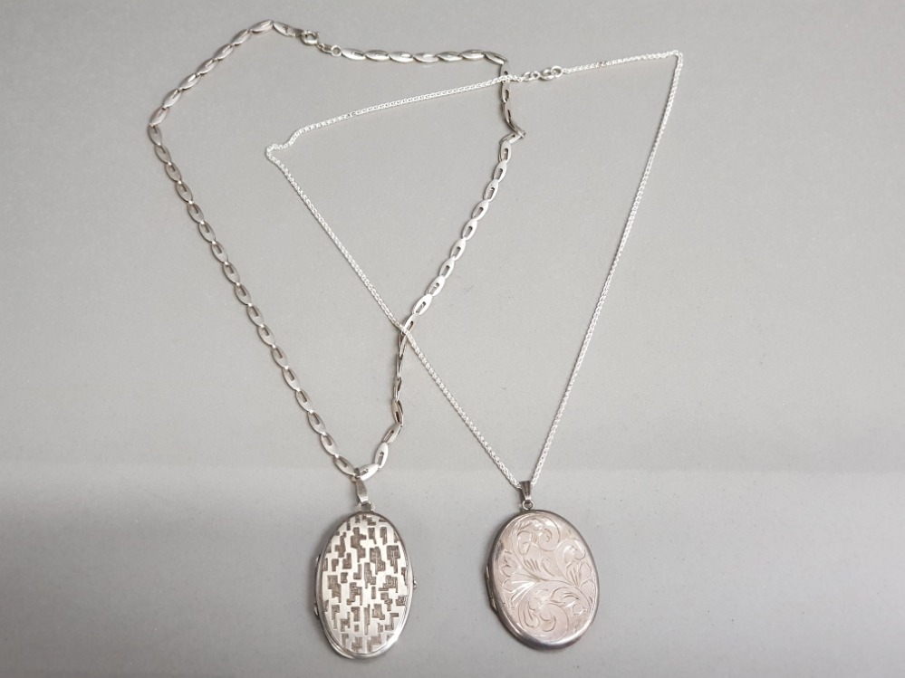 2x ladies oval shaped silver lockets with chains, both engraved, 42.4g