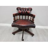 Metal studded leather Chesterfield captains armchair in ox blood on swivel base