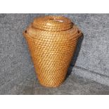 A twin handles reed linen basket with lid.