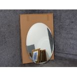 Large frameless oval shaped mirror, with both horizontal and vertical hooks to back, boxed