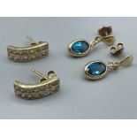 2 x gold stone set studs. 1 blue topaz and 1 CZ double row.