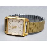 A gents Ingersol square faced gold coloured wristwatch.