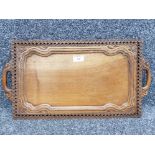 A 20th century Chinese carved wooden tray 53cm wide.