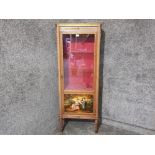 A continental 18th century style display cabinet with brass gallery and mounts, glazed door and