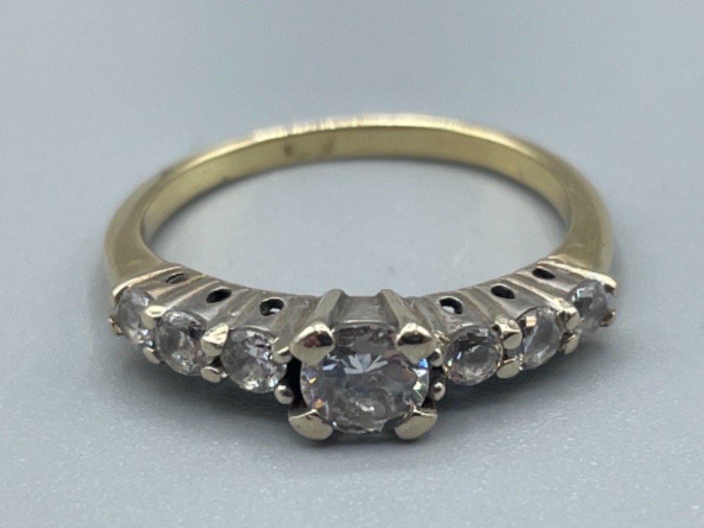 Gold CZ ring set with single stone in centre and 3 stones either side. 2.5G size L1/2