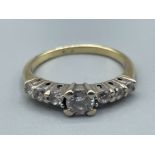 Gold CZ ring set with single stone in centre and 3 stones either side. 2.5G size L1/2