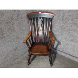 An antique elm seated Windsor back kitchen armchair.