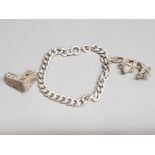 A silver bracelet with two white metal charms in the form of a church and gondola 36g gross.