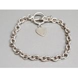 A silver Albert chain converted to a bracelet, with white metal heart shaped charm 17.1g gross.