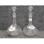 A pair of cut glass decanters with ceramic port and rum labels