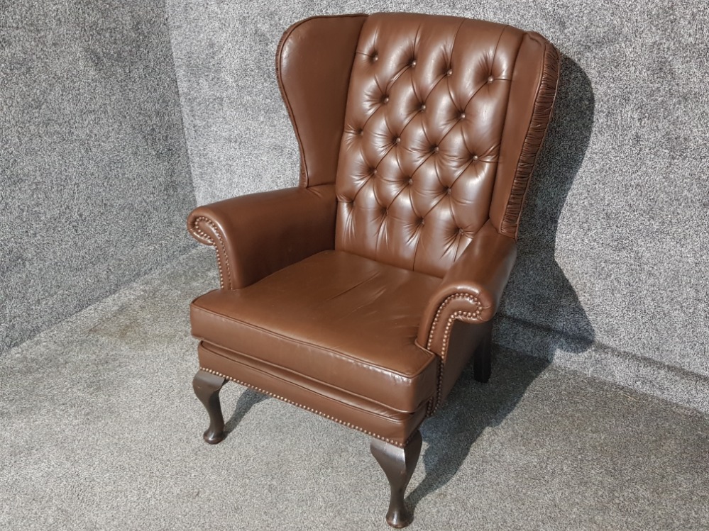 Brown leather metal studded wing back armchair, button back with mahogany feet - Image 2 of 2