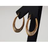 A pair of 9ct yellow gold oval hooped earrings with white gold detailing .83g