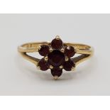 A 9ct yellow gold and garnet cluster ring size N1/2 1.67g grose