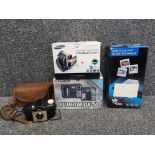 A Kodak Brownie 127 camera, Samsung Digital Cam, Fujifilm DX-10 digital camera, and a 5MP film and