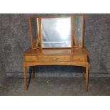 An oak three drawer dressing table with triptych mirror.