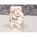 Japanese handcarved bone Netsuke in the form of a village elder with hammer