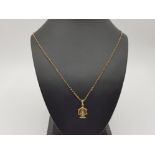 A 9ct yellow gold menorah pendant on chain 59cm long