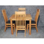 A light oak dinning room table and four chairs.