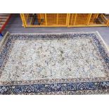 A large Kashmir rug with animal and floral motifs on cream ground 299 x 197cm