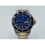 Rolex Submariner 18ct gold Bi metal with blue face and bezel. Full length strap and good work order.