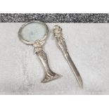 Magnifying glass and letter opener depicting woman