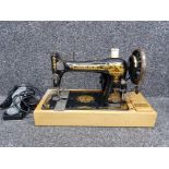 A Singer sewing machine no R1210811, with electric peddle, in fitted case