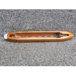 A wooden weaving shuttle with metal mounts 48cm long