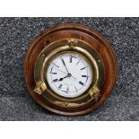 Brass porthole Weathermaster wall clock on wooden circular base