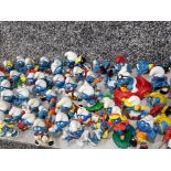 Box containing a large quantity of vintage smurf toys, some by Peyo