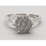 Ladies 9ct white gold diamond cluster ring featuring 7 round brilliant cut diamonds,