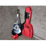 Black acoustic guitar in red fitted bag.