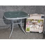 Valancia 3 piece bistro set, boxed, and an outdoor table.