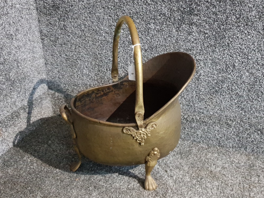 A Victorian brass helmet shaped coal scuttle