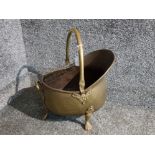 A Victorian brass helmet shaped coal scuttle