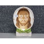 A pottery plaque depicting jesus 28.5cm high
