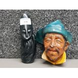 A soapstone carving depicting an abstract figure signed E Mushinga and a wall plaque by Bossons