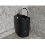 A black metal coal scuttle