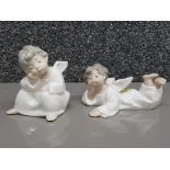Two Lladro angels in different poses.