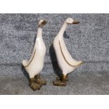 A pair of hand painted geese sculptures 55cm high