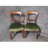 A pair of Victorian mahogany balloon back dining chairs.