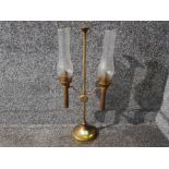 A vintage brass twin branch oil lamp with glass chimneys 61cm high