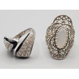 Two silver rings to include one with black enamel decoration size R1/2 and size P 14.6g gross