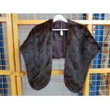 A brown fur stole with pockets